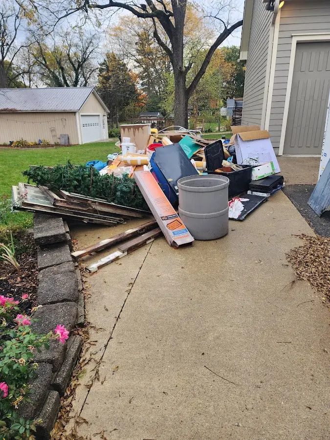 Dumpster being loaded with debris for Estate Cleanout Dumpster Rental in Hickman